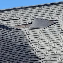 Shingle tab lifted up from the roof surface