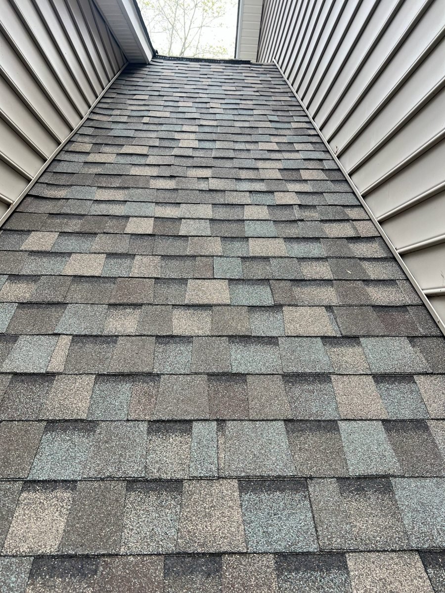 Close-up of architectural shingles along a second-story sidewall