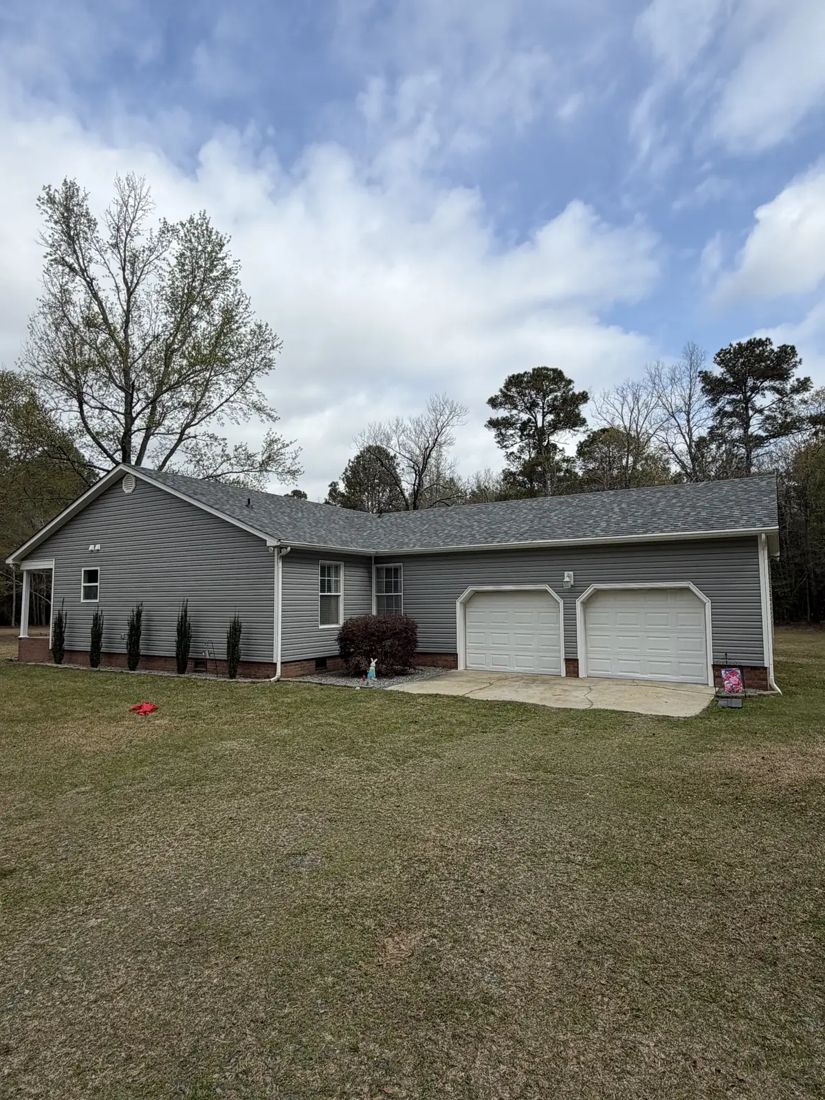 One-story home with a two-car garage and gray shingle roof