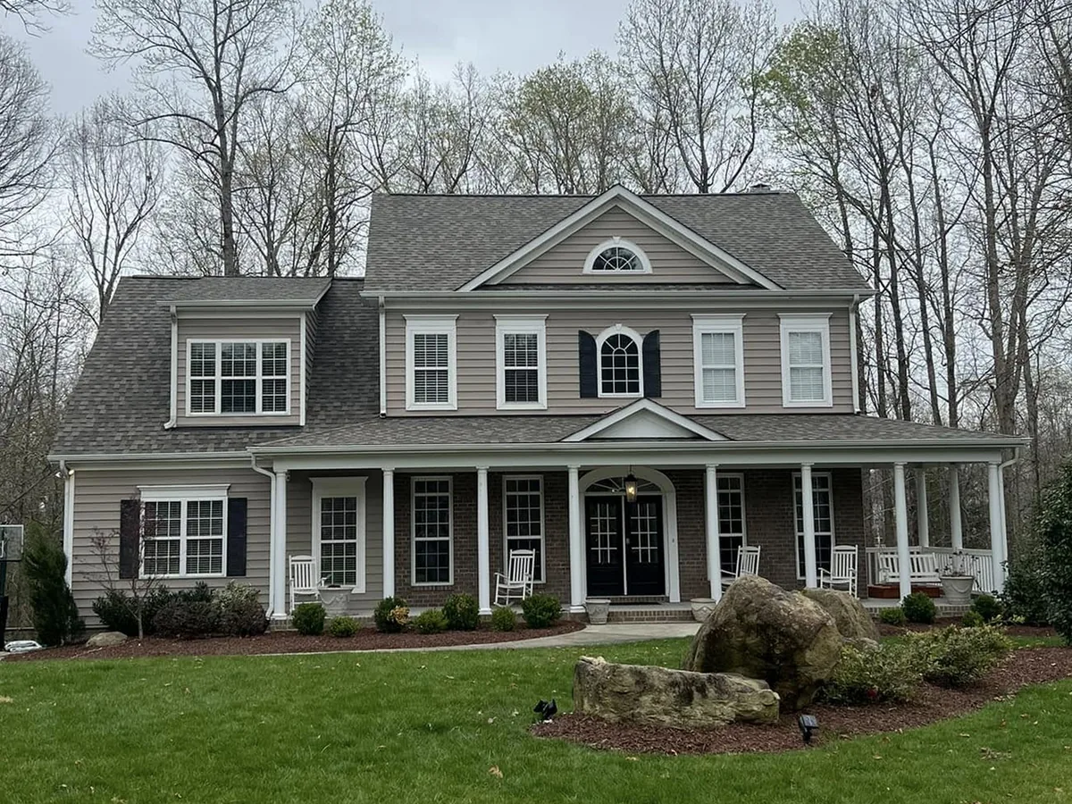 Gray two-story house with a front porch and shingle roof